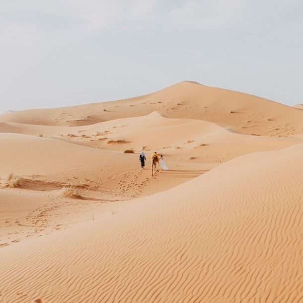 Sahara desert in Erg Chebbi Based in Morocco with two people walking in the landscape